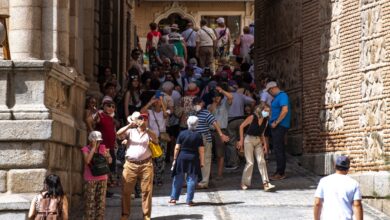 Turistas fotografían la catedral de Toledo guareciéndose del sol en la sombra que proyecta el edificio del ayuntamiento. EFE/Ismael Herrero