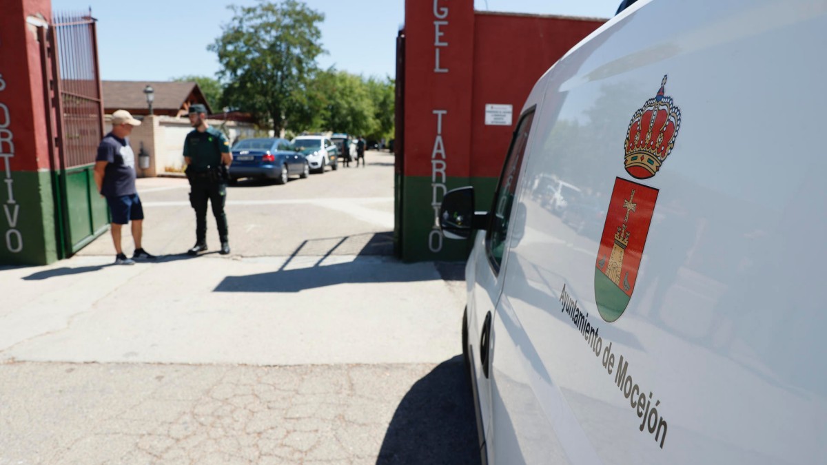 MOCEJÓN (TOLEDO), 18/08/2024.- Un agente de la Guardia Civil habla con un vecino en la entrada al campo de fútbol de Mocejón (Toledo) donde un niño de 11 años ha muerto este domingo tras ser agredido con un objeto punzante. La Guardia Civil ha desplegado un amplio dispositivo para localizar al homicida. EFE/Ismael Herrero